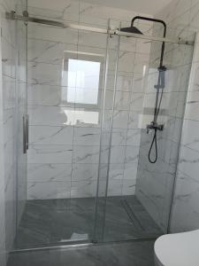 a shower with a glass door in a bathroom at Eurouna relax in Bosanska Krupa +16 photos