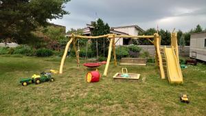 a group of playground equipment in a yard at Namelis Pušų pakrašty in Palanga