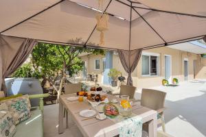 a table with food on it on a patio at La Fleur in Chania
