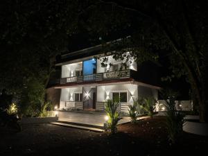 a night view of a building with a blue light at The creek house morgim in Morjim