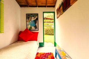 a room with a bed and a door with a window at Kantarrana Casa de Campo in Jardin