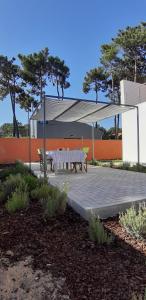 a pavilion with a picnic table and a bench at Casa da Falésia in Almada +33 photos