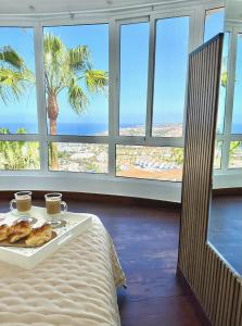 a room with a table with a tray of pastries on it at Luxury Villa Taoro private heated pool Free Car Except Christmas in Adeje +46 photos