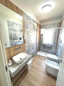 a bathroom with a sink and a toilet and a shower at Villa Andromeda apartments in Realmonte