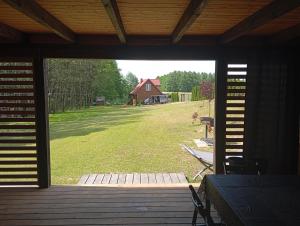 an open porch with a view of a yard with a barn at Działka u Zbycha - na wyłączność - duży teren 