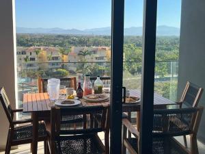 a table with food and drinks on a balcony at Aria Ocean Playa Nuevo Vallarta in Nuevo Vallarta 