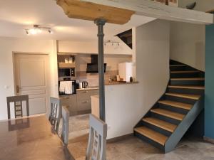 a staircase in a room with a kitchen and a kitchen at Gites de la Varillère in Cuzion