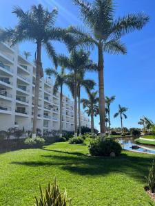 a resort with palm trees and a building at Aria Ocean Playa Nuevo Vallarta in Nuevo Vallarta 
