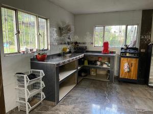 a kitchen with a counter and a stove in it at Finca de descanso Los Polos in La Mesa