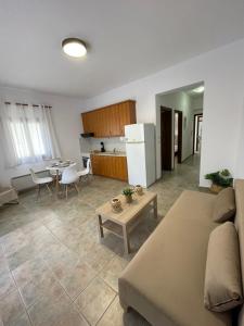 a living room and kitchen with a couch and a table at Melivia apartments in Ierissos