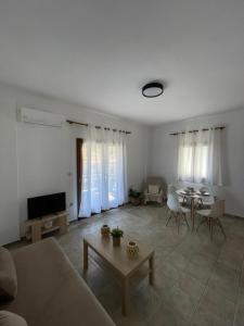 a living room with a couch and a table at Melivia apartments in Ierissos
