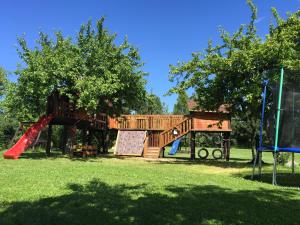 a playground in a park with a slide at Dworek Biebrzański in Augustów
