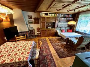 a living room with a bed and a couch and a table at Ferienhaus Moßhammer in Lofer
