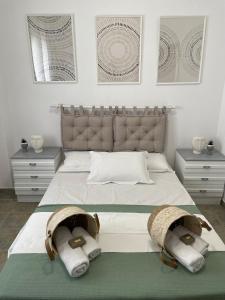 a bedroom with a large bed with towels on it at Melivia apartments in Ierissos
