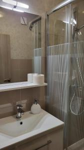 a bathroom with a sink and a shower at Padova 2 in Rab +37 photos