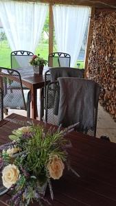 a table and chairs with flowers on top of it at Penzion Villa Marion in Mariánské Lázně