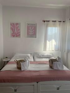 a bedroom with a bed with two baskets on it at Melivia apartments (2) in Ierissos