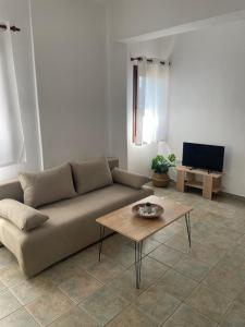 a living room with a couch and a coffee table at Melivia apartments (2) in Ierissos