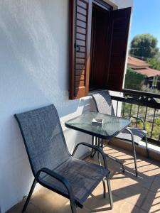 a patio with a table and chairs on a balcony at Melivia apartments (2) in Ierissos