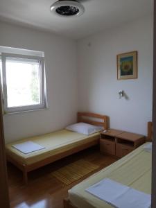 Postel nebo postele na pokoji v ubytování APARTMAN ZVONIMIR