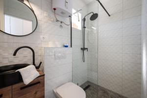 a bathroom with a shower with a toilet and a sink at Ante room's in Trogir