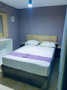 Кровать или кровати в номере Greyview