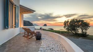 a balcony with a bench and a view of the ocean at Villa Marisol in Pollonia