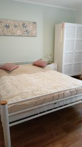 a bed frame in a bedroom with a mattress at Penzion Villa Marion in Mariánské Lázně