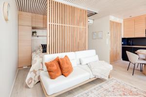 a living room with a white couch and a bed at Mainingin Loiste C2 - Luxury holiday in Kalajoki
