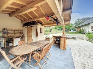 a large wooden table and chairs on a patio at CHALET DON PAPA in Saint-Martin-Vésubie