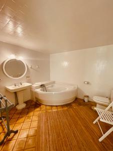 a bathroom with a large tub and a sink at Casal d'Artà by Baudot 1926 - Adults Only in Artá