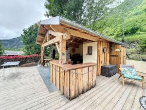 a wooden building with a bar on a deck at CHALET DON PAPA in Saint-Martin-Vésubie +29 photos