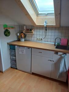 a kitchen with a sink and a counter top at Apartment Moosblick zwischen Bergen und See in Benediktbeuern
