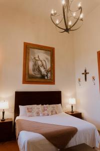 Postel nebo postele na pokoji v ubytování Hacienda San Nicolas de las Fuentes