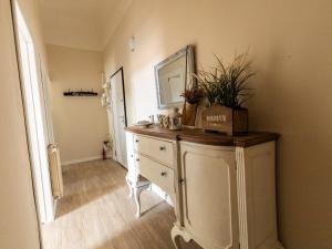 a room with a dresser with a mirror and plants on it at La casa di Gazi in Florence