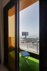 a room with a view of the ocean from a window at Alex Inn in Alexandria