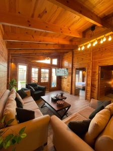 a large living room with a couch and a table at اكواخ السمو الريفيه in Khalij Salman