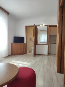 an empty living room with a table and a kitchen at Apartments Glavinović - Near Beach and Center, Free Parking in Povlja