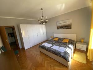 a bedroom with a bed and a chandelier at SLAVANTE RESIDENCE in Rijeka