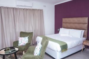 Pristine Guest Apartments tesisinde bir odada yatak veya yataklar