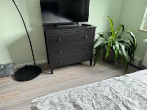 a bedroom with a dresser with a tv on it at Kleine FeWo auf m Hasten in Remscheid
