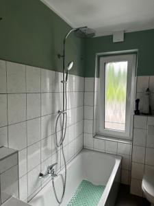 a bathroom with a shower and a bath tub at Kleine FeWo auf m Hasten in Remscheid
