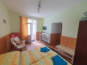 a bedroom with a bed and a living room at Apartmány Slavín in Sklené Teplice