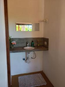 a bathroom with a sink and a mirror at Canto do sossego in Gonçalves +47 photos