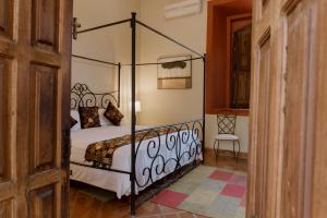 Postel nebo postele na pokoji v ubytování Hacienda San Nicolas de las Fuentes
