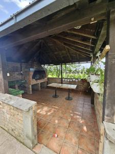 an outdoor patio with a bench and a table at La bella vue in Osenjače
