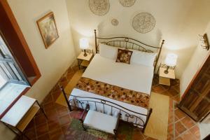 Postel nebo postele na pokoji v ubytování Hacienda San Nicolas de las Fuentes