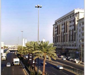 a street with palm trees in front of a building at شقق نرمادا المفروشه402 in Medina