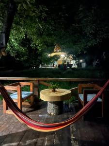 a hammock and a table and a table and chairs at Ioska's House in Mestia