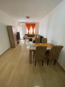 a living room with a table and a couch at Azra apartment City kvart in Podgorica